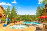 Shared pool and hot tubs at Dakota Lodge in summer